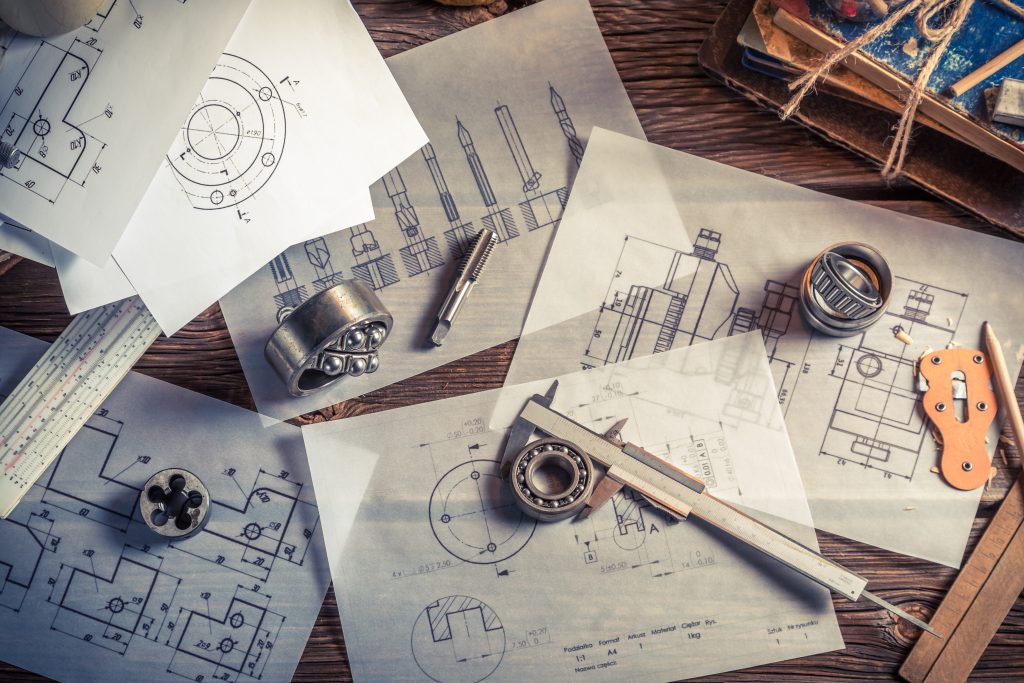 Bearings and drawings on a table with calipers